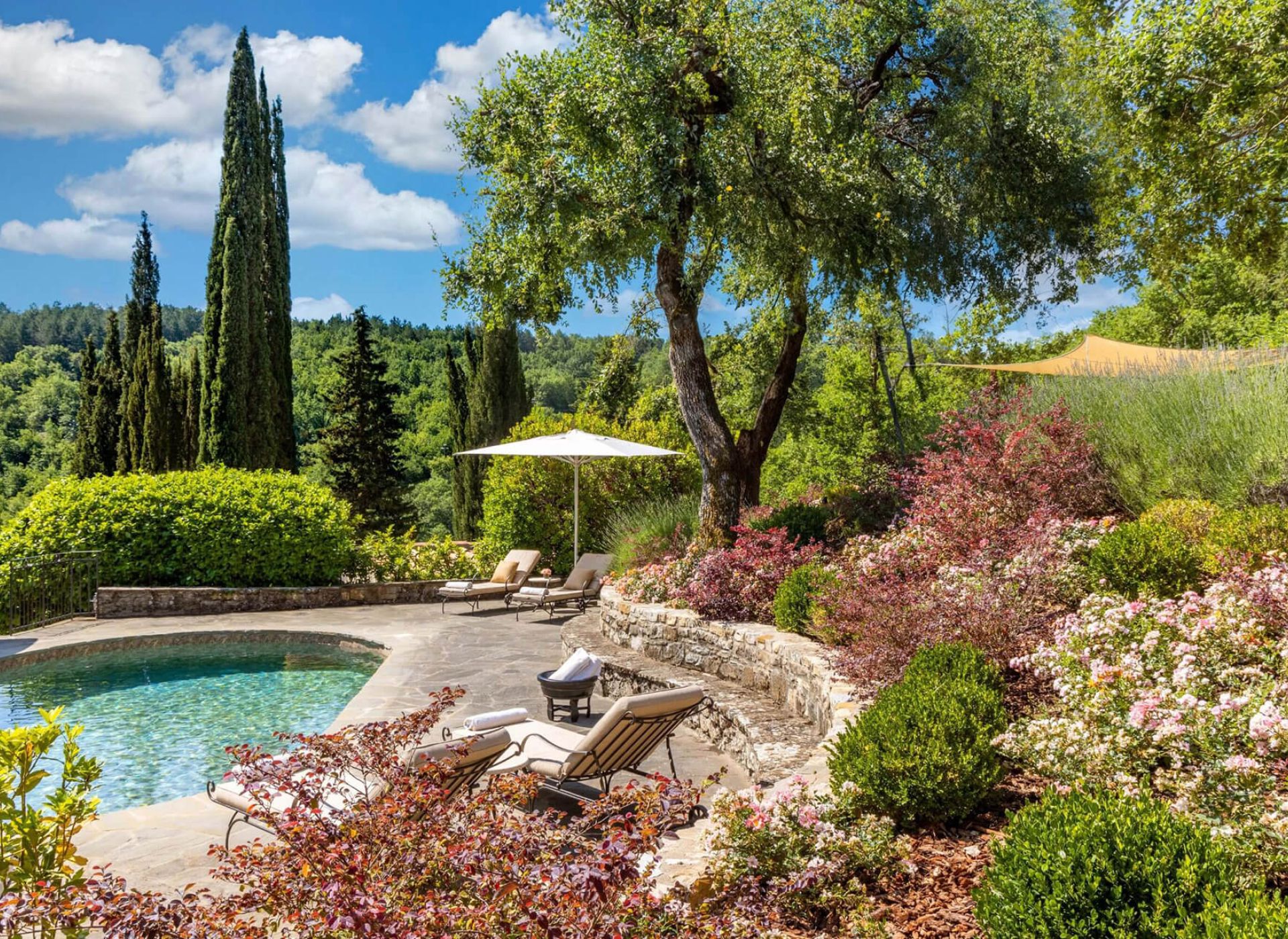 Arched Tuscan interior with fireplace, chandelier and terracotta floors