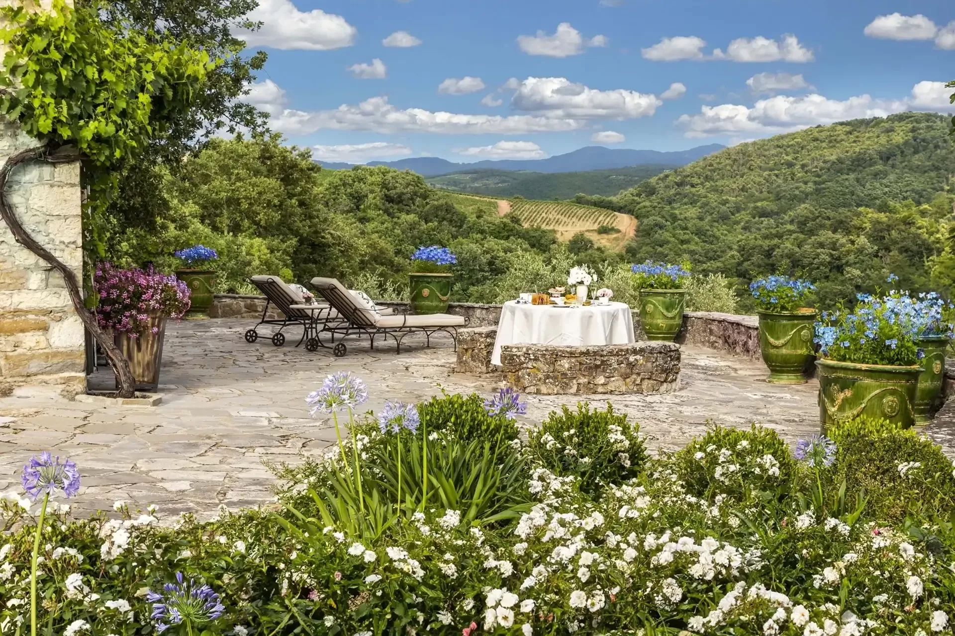Stone terrace overlooking vineyards and hills at Tenuta Ceccatelli