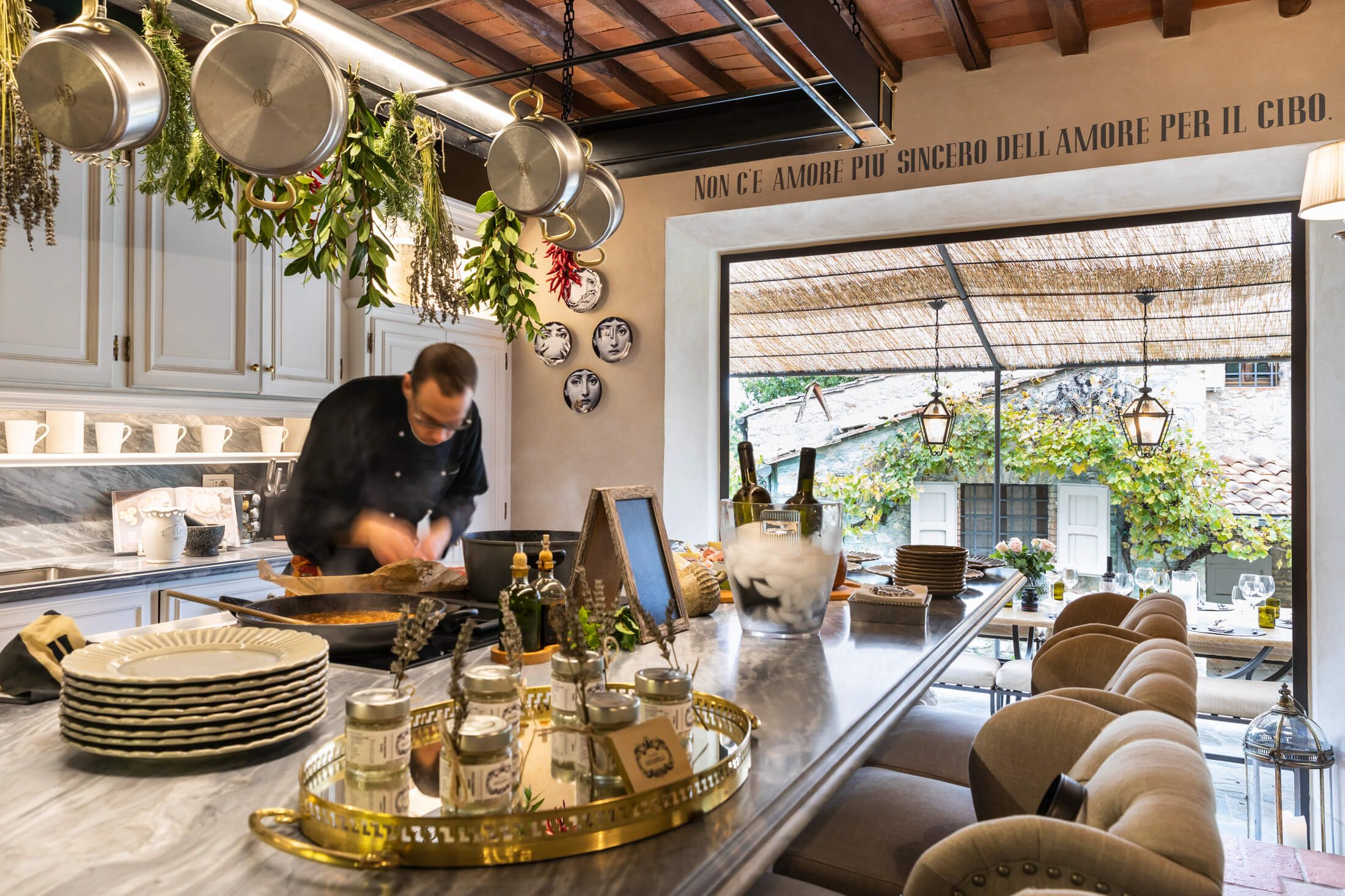 Chef preparing a meal in the open kitchen at Tenuta Ceccatelli